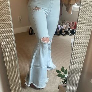 Awesome bellbottom, light colored jeans with holes in them! Vibrant brand size 7